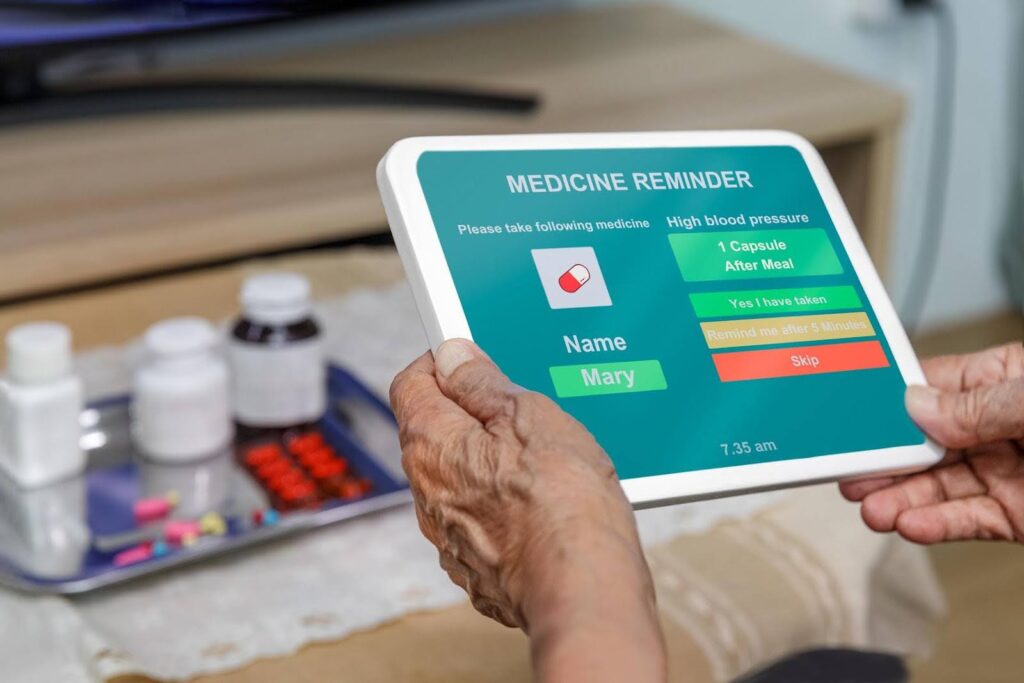 Senior holding a smart tablet displaying a medication reminder app with options to confirm, snooze, or skip taking high blood pressure medication.
