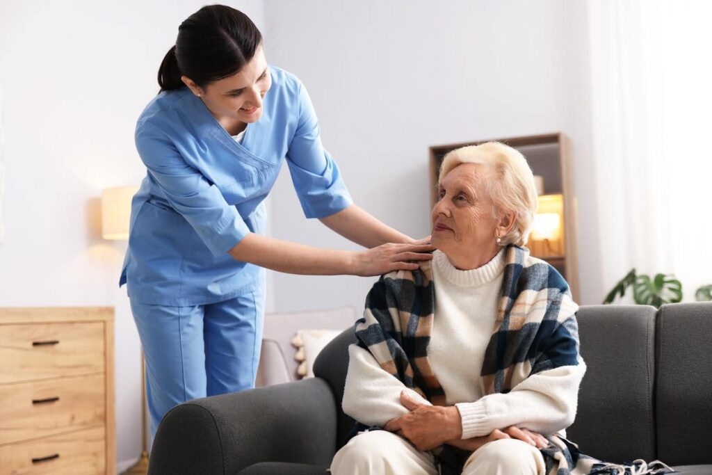 A caregiver gently supporting a senior woman at home, representing Ace Home Care’s personal assistant approach to aging in place with dignity.