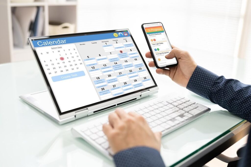 Person using laptop and smartphone to manage a care schedule, reviewing calendar tasks to choose between part-time, full-time, or 24/7 care options.