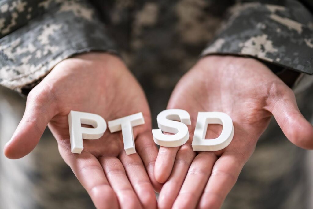 Hands of an older adult holding PTSD letters, symbolizing trauma-informed personal care and support for seniors living with PTSD.