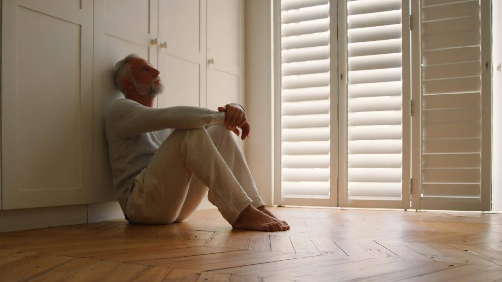 Ace Home Care caregiver identifying early signs of depression in an older adult sitting alone at home.