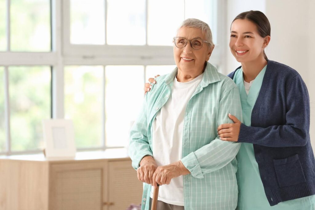 Smiling senior woman with caregiver at home, representing the Transition from family help to professional support with Ace Home Care and trusted home care services.