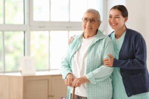 Smiling senior woman with caregiver at home, representing the Transition from family help to professional support with Ace Home Care and trusted home care services.