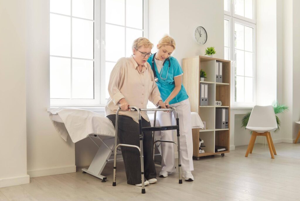 Senior receiving mobility assistance at home illustrating the difference between living alone and living safely with Ace Home Care