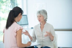 Senior discussing home care insurance coverage options with a professional from Ace Home Care