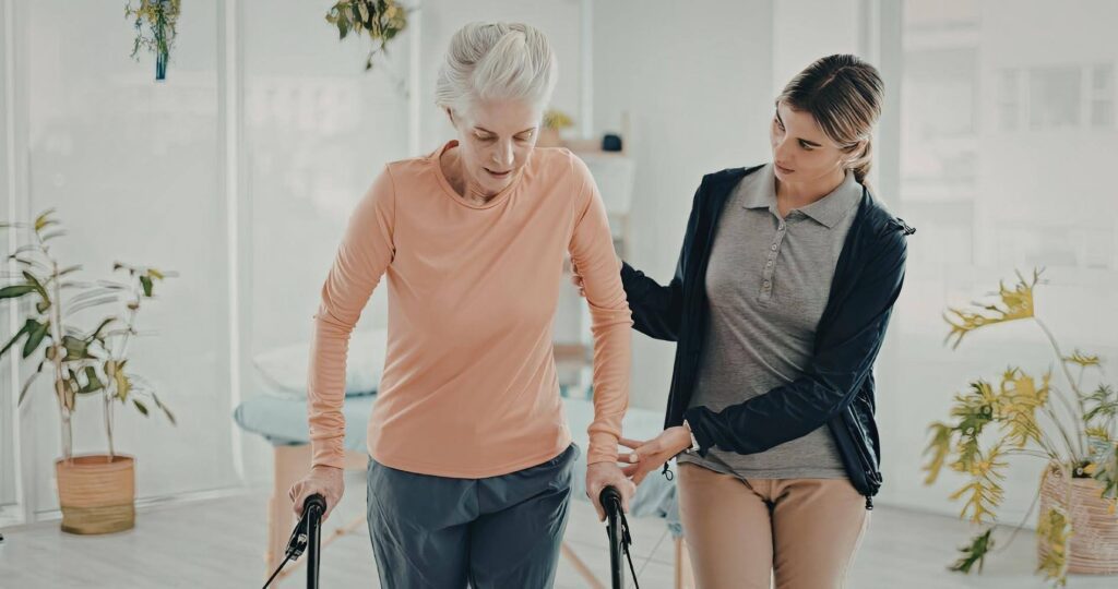 Caregiver providing concierge-level support to a senior using a walker at home with Ace Home Care