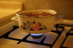 Pot left on a stove highlighting a common senior safety risk managed by Ace Home Care
