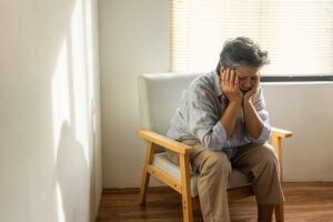 Senior sitting alone feeling embarrassed and overwhelmed as Ace Home Care discusses why embarrassment can prevent seniors from asking for help