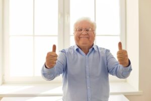 Smiling senior giving a thumbs-up at home, illustrating the importance of checking whether an elderly parent is truly okay and maintaining their well-being with support from Ace Home Care