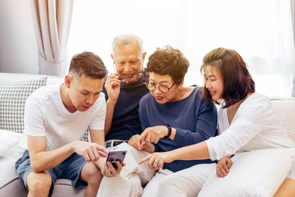 Family spending a weekend together with elderly parents at home, highlighting Ace Home Care's weekend support services for seniors and family caregivers.