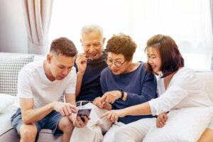 Family spending a weekend together with elderly parents at home, highlighting Ace Home Care's weekend support services for seniors and family caregivers.