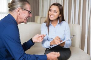 Caregiver patiently listening and responding to an older adult with repeated questions, highlighting Ace Home Care's compassionate approach to supporting seniors with memory challenges.