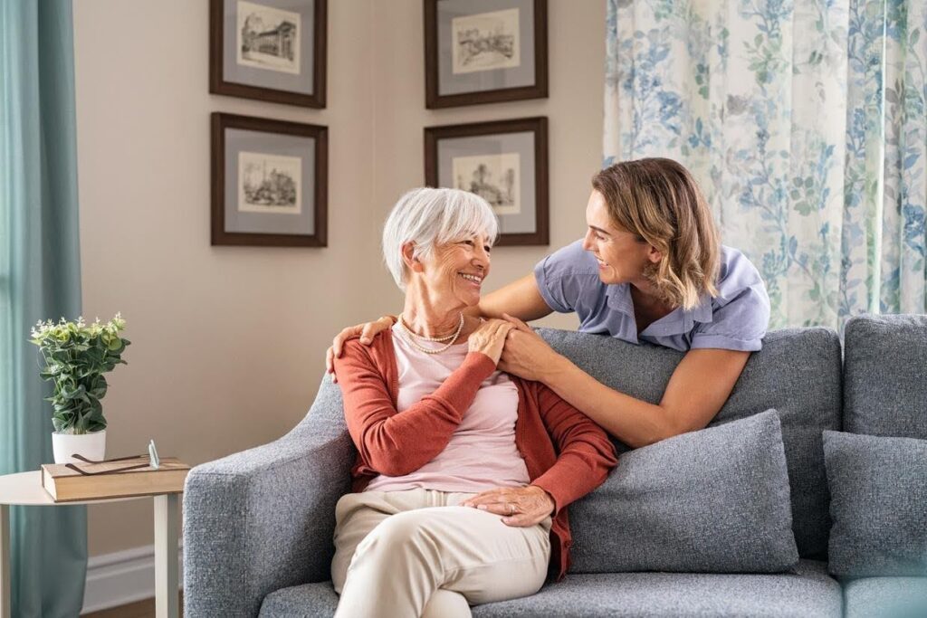 Compassionate caregiver talking with an older adult at home, highlighting the early signs an aging parent may need home care services from Ace Home Care to remain safe and independent.