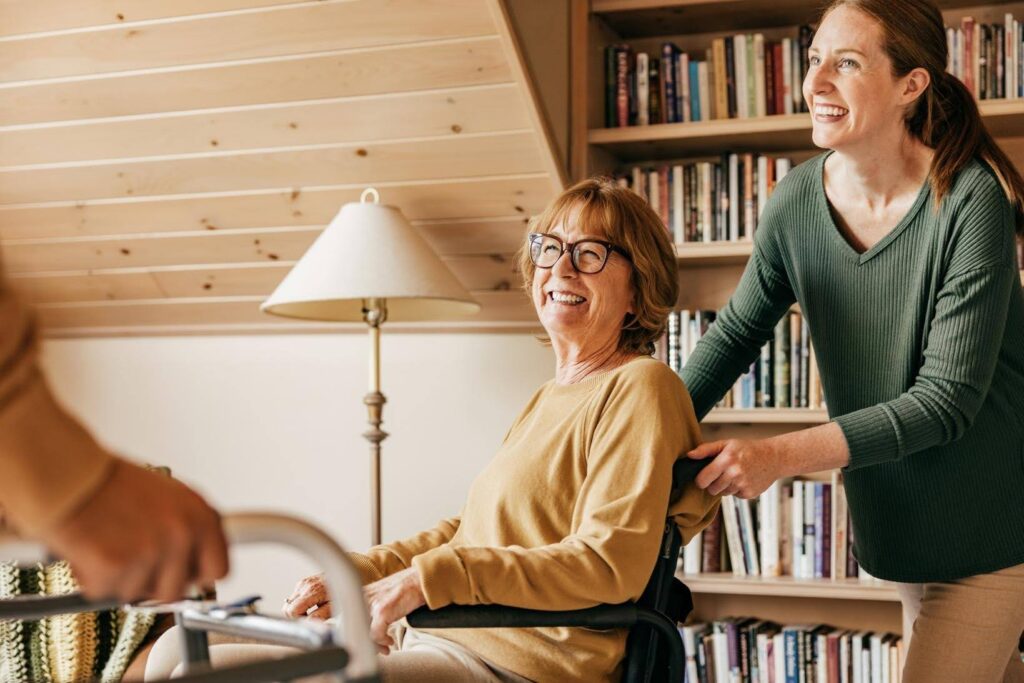 Caregiver supporting an aging parent with mobility at home, helping her stay engaged, comfortable, and connected with others through Ace Home Care.
