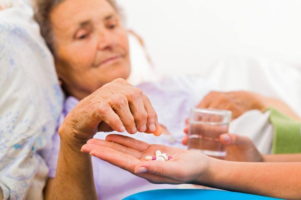 Senior managing a medication routine at home as family phone reminders become less reliable, highlighting medication support from Ace Home Care.