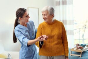 Caregiver assisting a senior woman with mobility as a family considers starting home care with Ace Home Care.