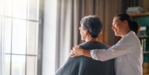 Caregiver supporting an older adult at home after a hospital stay, highlighting when home care from Ace Home Care may be needed during recovery.