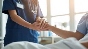 Caregiver providing reassuring support to an older adult after hospital discharge, highlighting the importance of continued care and recovery at home.