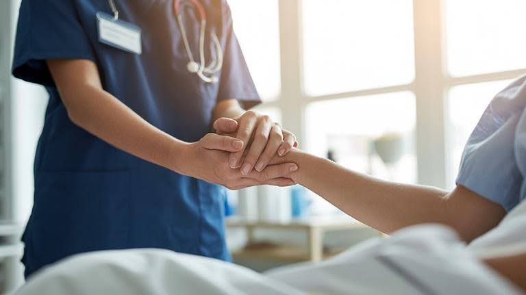 Caregiver providing reassuring support to an older adult after hospital discharge, highlighting the importance of continued care and recovery at home.