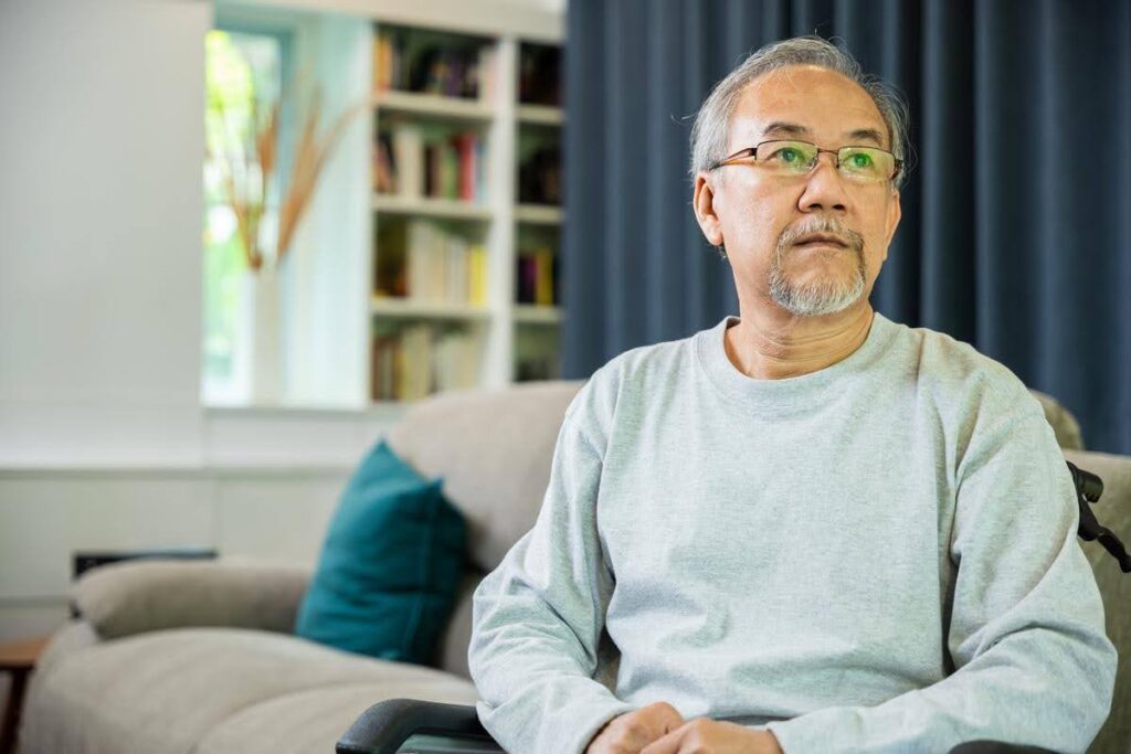Older man sitting alone in a wheelchair at home, highlighting the importance of reliable home care when a family caregiver is no longer available.