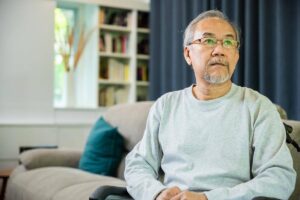Older man sitting alone in a wheelchair at home, highlighting the importance of reliable home care when a family caregiver is no longer available.